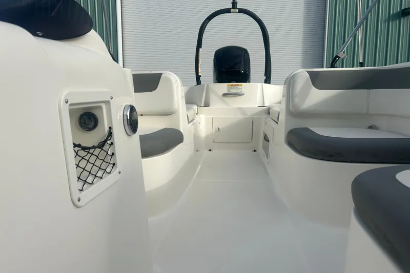 Slide: The Image of 2016 Bayliner Element XL boat interior with seating and storage compartments. - 30