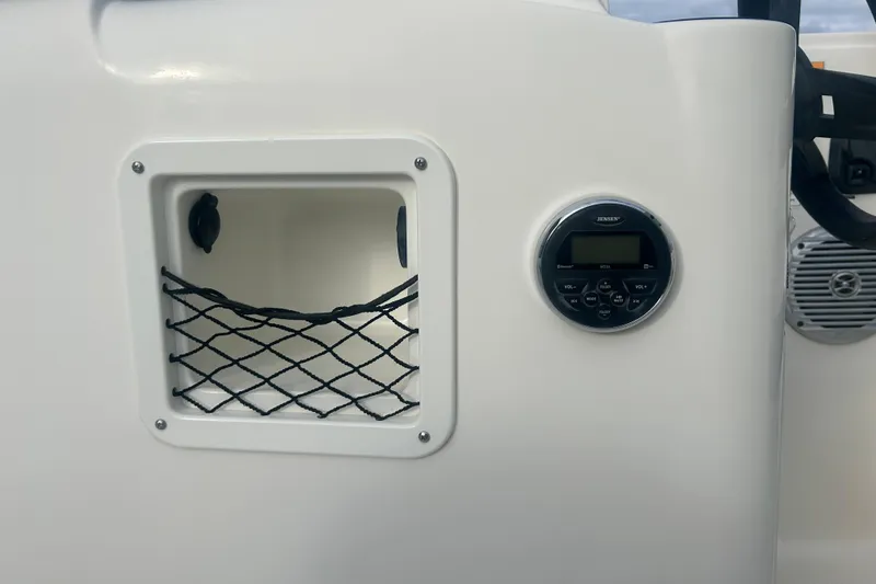Slide: The Image of 2016 Bayliner Element XL boat dashboard with storage net and Jensen audio system. - 31