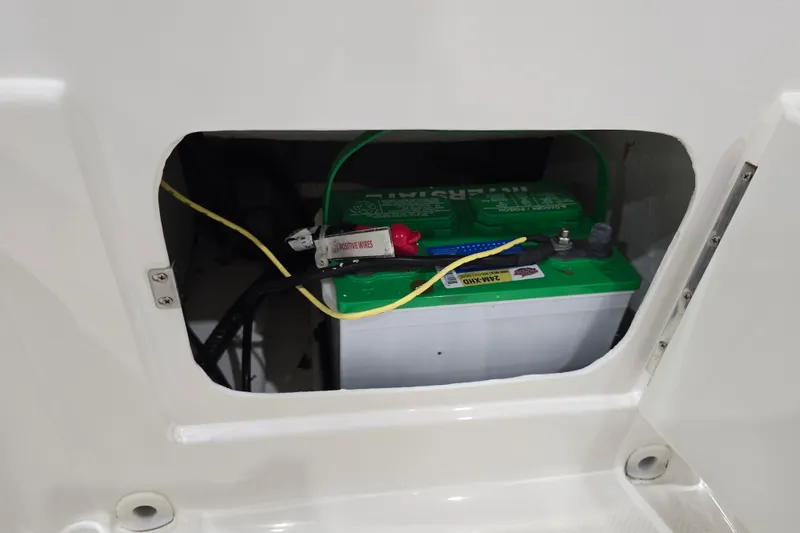 Slide: The Image of Battery compartment of 2016 Bayliner Element XL boat with visible wiring. - 32
