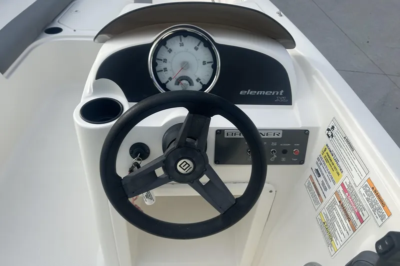 Slide: The Image of 2016 Bayliner Element XL boat dashboard with steering wheel and speedometer. - 33