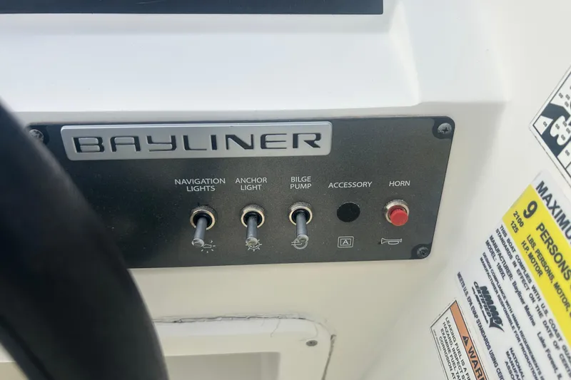 Slide: The Image of Control panel of 2016 Bayliner Element XL boat with switches and capacity warning. - 34