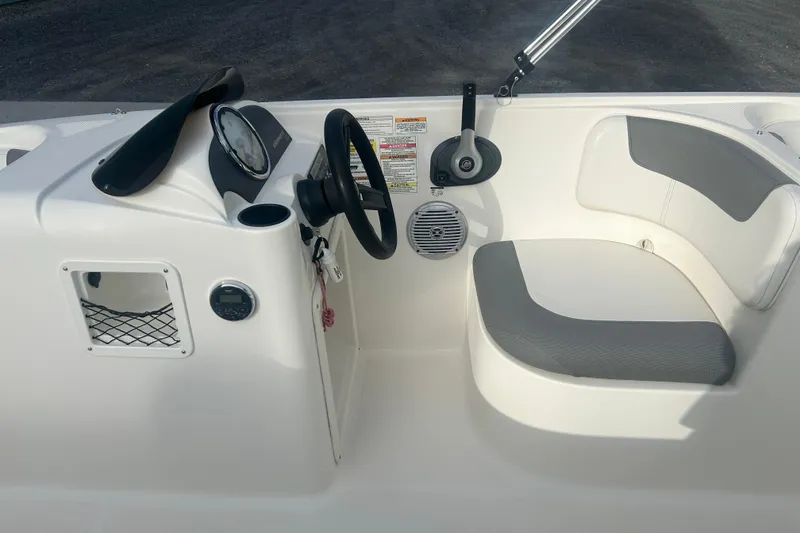 Slide: The Image of 2016 Bayliner Element XL boat interior with steering wheel and seating area. - 36