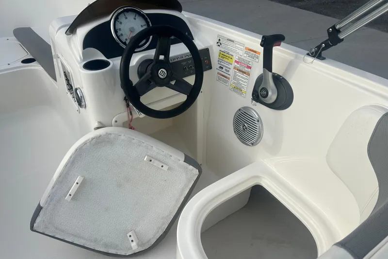 Slide: The Image of 2016 Bayliner Element XL boat cockpit with steering wheel and control panel. - 37