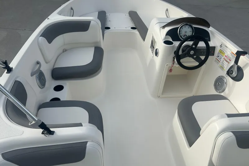 Slide: The Image of 2016 Bayliner Element XL boat interior with gray seating and steering console. - 43