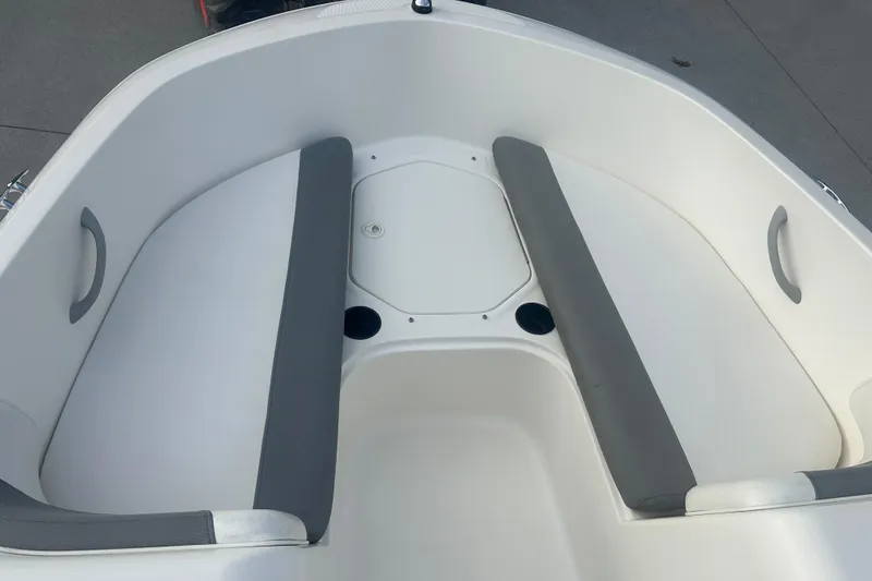 Slide: The Image of 2016 Bayliner Element XL boat interior with gray seating and storage compartment. - 44