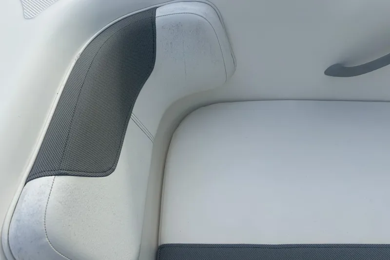 Slide: The Image of 2016 Bayliner Element XL boat seat with white and gray upholstery. - 49