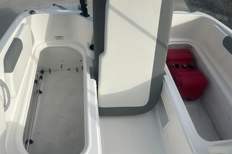 Slide: The Image of 2016 Bayliner Element XL boat interior storage compartments with red fuel tank. - 52