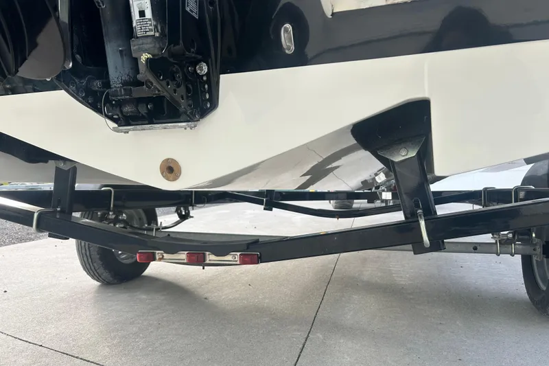 Slide: The Image of 2016 Bayliner Element XL boat on trailer, rear view showing hull and motor. - 59