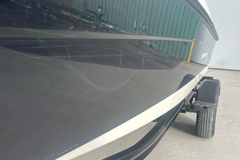 Slide: The Image of 2016 Bayliner Element XL boat on trailer, side view with visible scratches. - 8