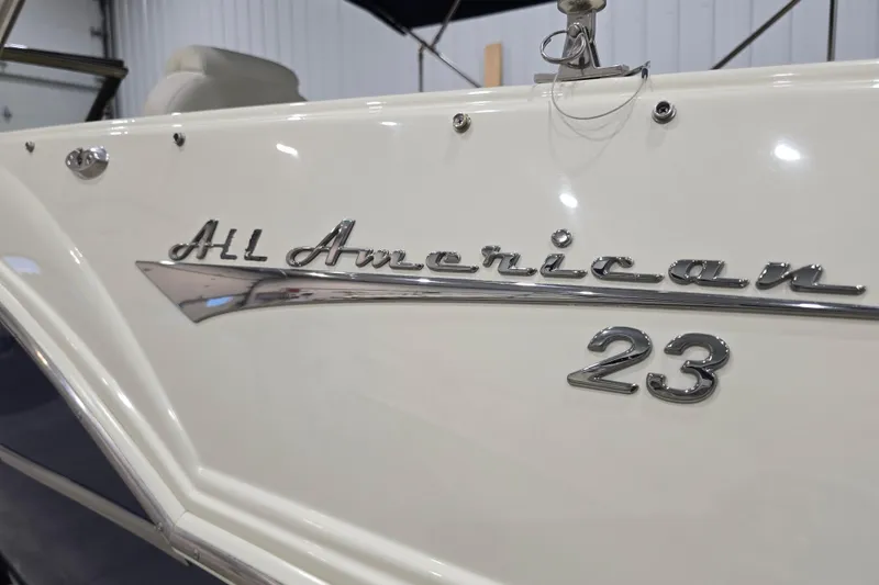 Slide: The Image of 2014 Larson All American 23 boat with chrome lettering detail. - 12