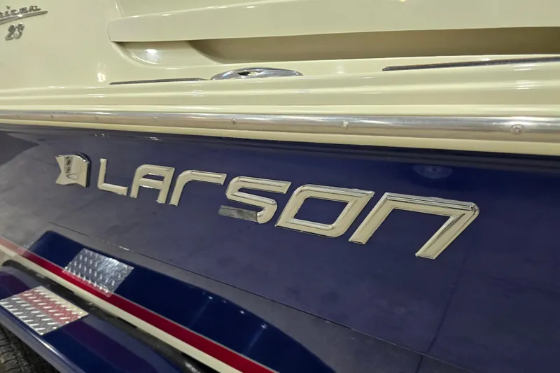 Slide: The Image of 2014 Larson All American 23 boat, close-up of logo and model name. - 13