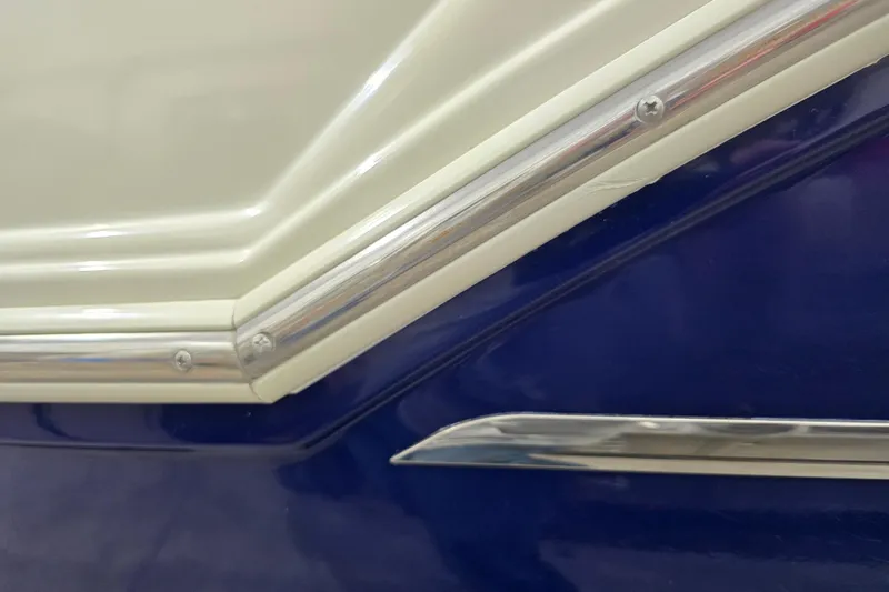 Slide: The Image of Close-up of 2014 Larson All American 23 boat detailing with blue and white trim. - 15