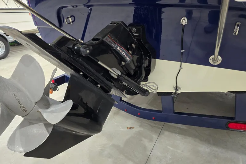 Slide: The Image of 2014 Larson All American 23 boat with Mercury outboard motor and propeller. - 19