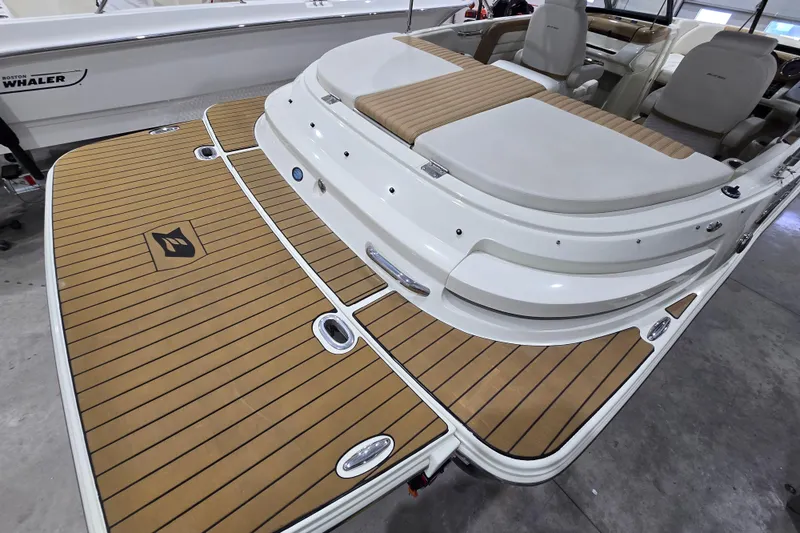 Slide: The Image of 2014 Larson All American 23 boat with teak-style deck and comfortable seating. - 26