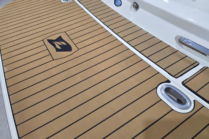 Slide: The Image of 2014 Larson All American 23 boat deck with wood finish and logo detail. - 27
