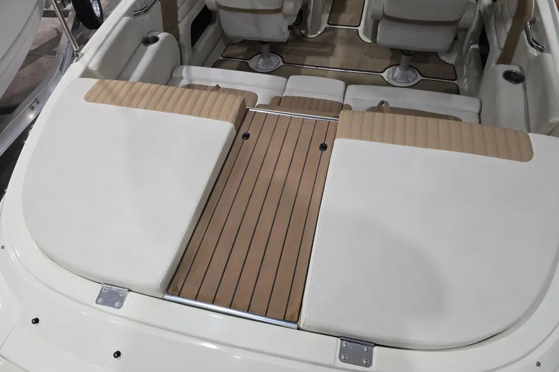 Slide: The Image of 2014 Larson All American 23 boat interior with cushioned seating and wood accents. - 28