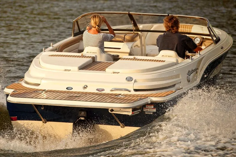 Slide: The Image of 2014 Larson All American 23 boat with blue and white exterior in a garage. - 3