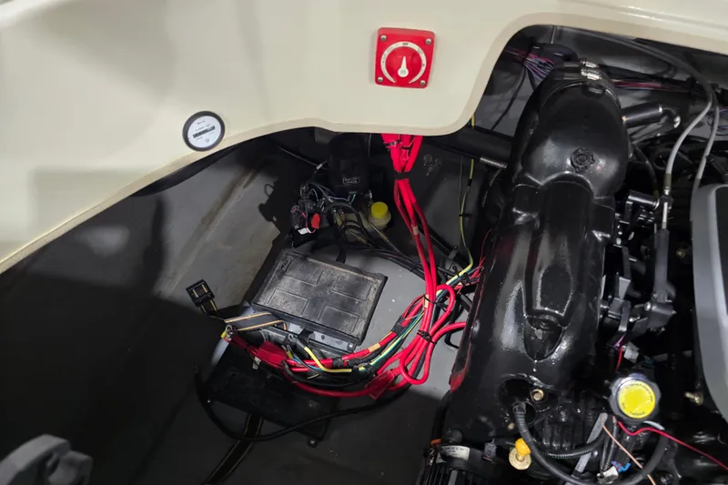 Slide: The Image of Engine compartment of a 2014 Larson All American 23 boat, showing wiring and components. - 32