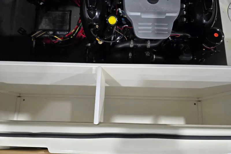 Slide: The Image of Engine compartment of a 2014 Larson All American 23 boat, showcasing mechanical components. - 34