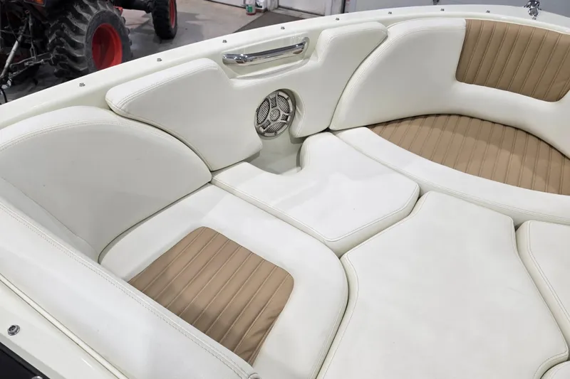Slide: The Image of 2014 Larson All American 23 boat interior with white and tan seating. - 37