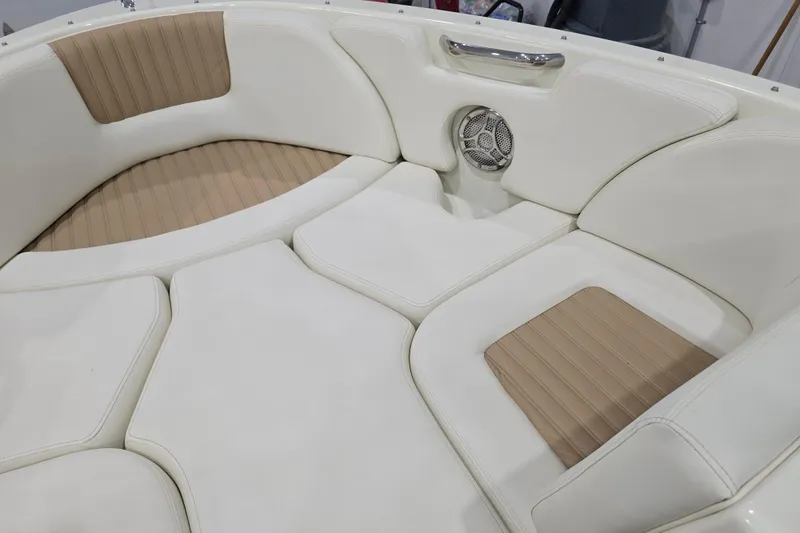 Slide: The Image of 2014 Larson All American 23 boat interior with white and tan cushioned seating. - 38