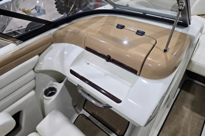 Slide: The Image of Interior of 2014 Larson All American 23 boat, featuring beige and white dashboard design. - 40