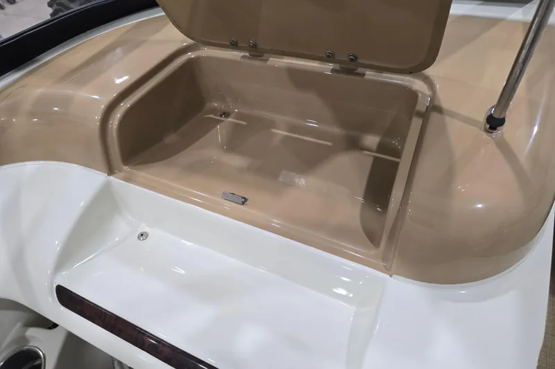 Slide: The Image of Open storage compartment on a 2014 Larson All American 23 boat, featuring beige and white interior. - 41