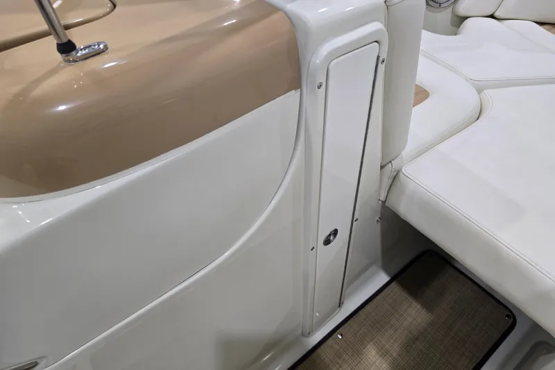 Slide: The Image of Interior of 2014 Larson All American 23 boat, featuring white seating and storage compartment. - 43