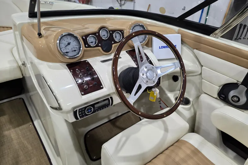 Slide: The Image of Interior of 2014 Larson All American 23 boat with classic steering wheel and dashboard. - 46