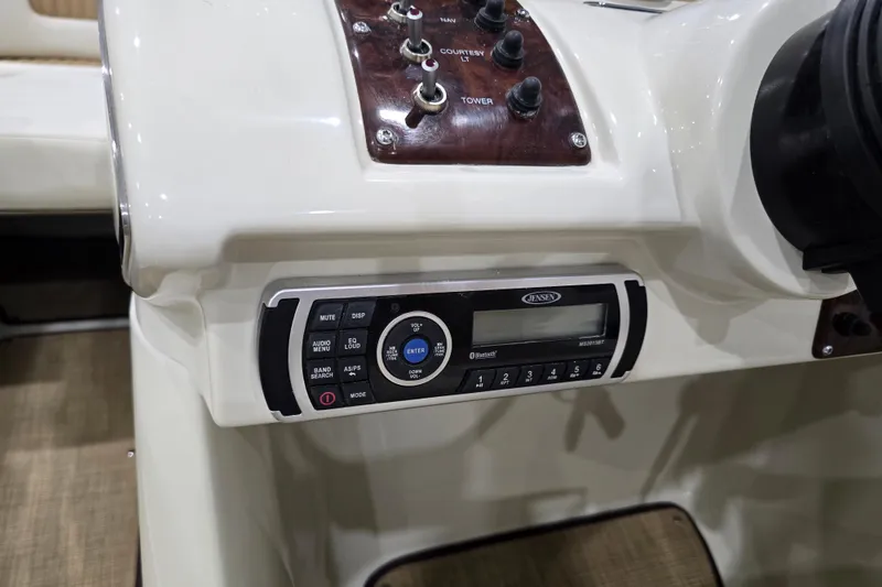 Slide: The Image of 2014 Larson All American 23 boat dashboard with Jensen audio system and control panel. - 47