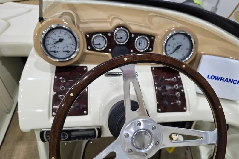 Slide: The Image of Steering wheel and dashboard of 2014 Larson All American 23 boat with gauges and controls. - 50