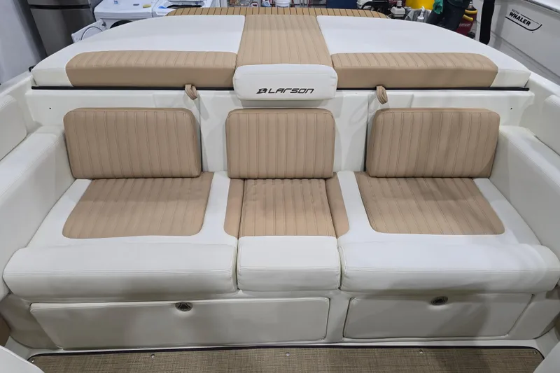 Slide: The Image of 2014 Larson All American 23 boat interior with beige and white seating. - 54