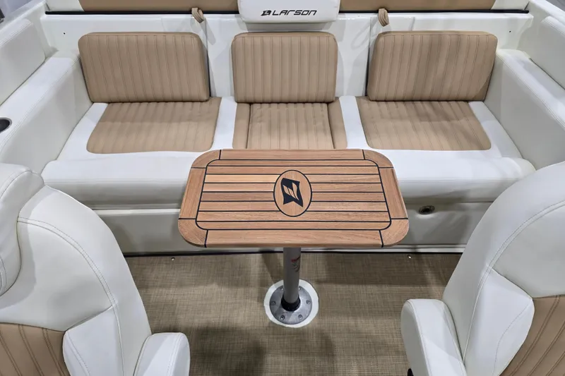 Slide: The Image of Interior of 2014 Larson All American 23 boat with beige seating and wooden table. - 55