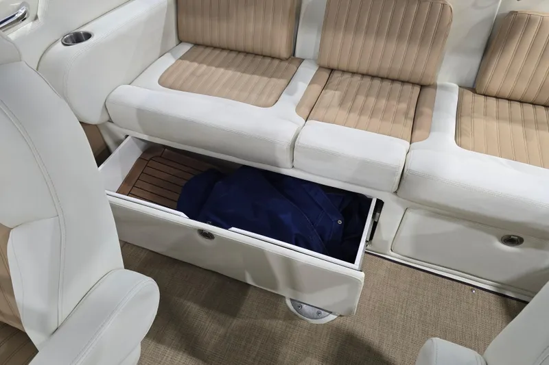 Slide: The Image of 2014 Larson All American 23 boat interior with storage under beige seating. - 59