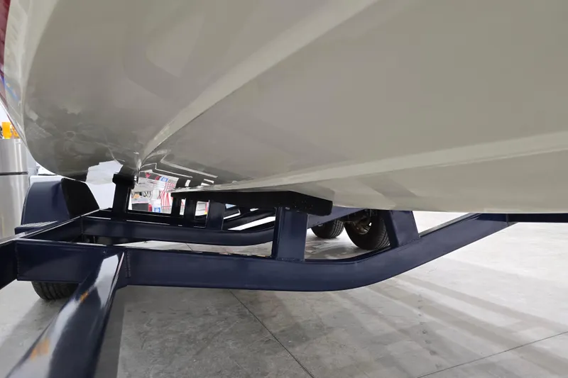 Slide: The Image of 2014 Larson All American 23 boat on trailer, underside view in a garage. - 65