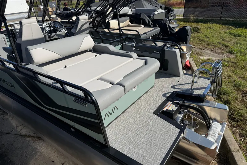 Slide: The Image of 2026 Avalon Venture boat with sleek seating and modern design, docked outdoors. - 3
