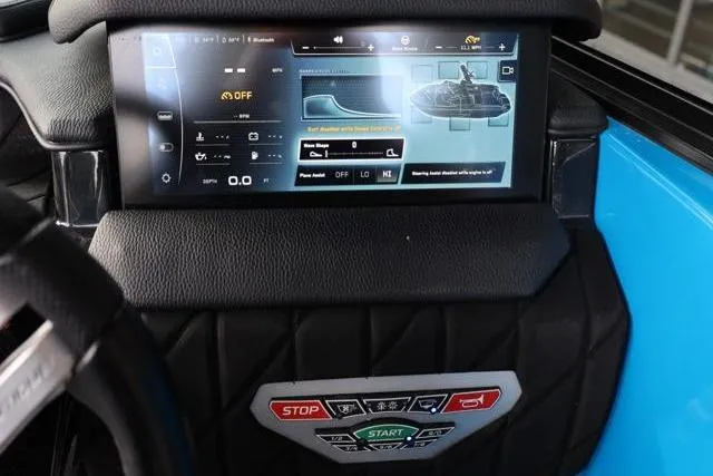 Slide: The Image of 2022 Nautique Super Air Nautique S23 dashboard with touchscreen controls and start-stop buttons. - 19