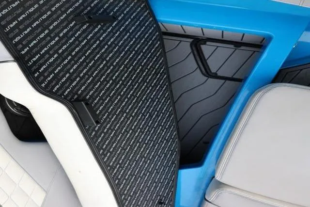 Slide: The Image of 2022 Nautique Super Air Nautique S23 interior with detailed flooring and seating design. - 25