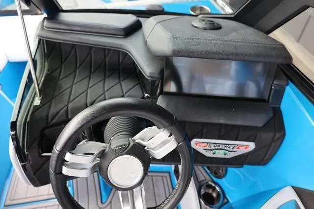 Slide: The Image of 2022 Nautique Super Air Nautique S23 dashboard with steering wheel and touchscreen display. - 28