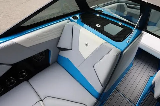 Slide: The Image of 2022 Nautique Super Air Nautique S23 interior with blue and gray seating, modern design. - 29