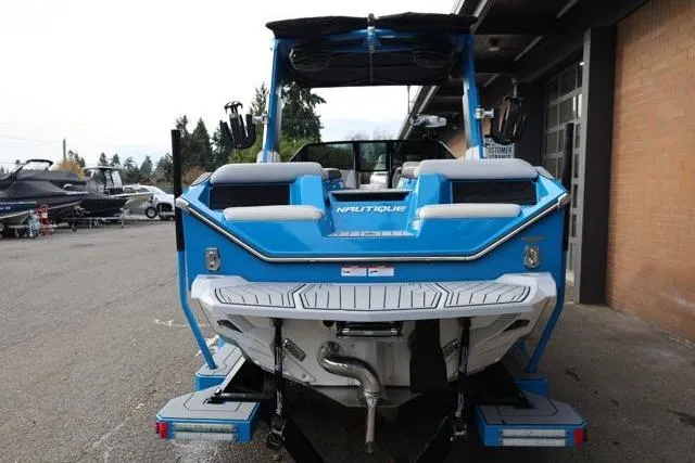 Slide: The Image of 2022 Nautique Super Air Nautique S23 boat, blue, rear view, parked outdoors. - 3