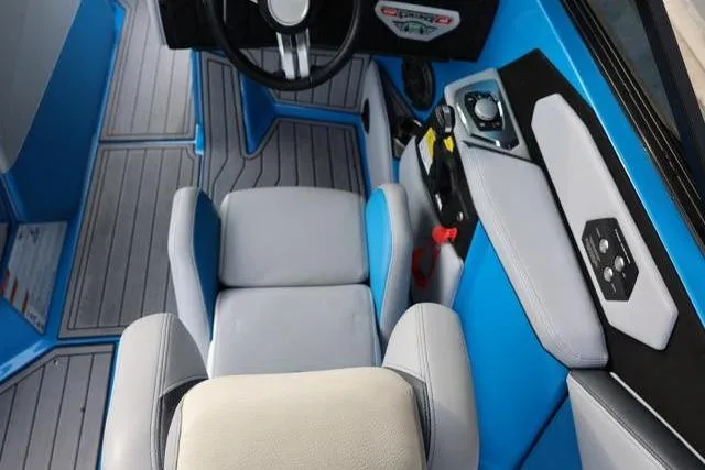 Slide: The Image of 2022 Nautique Super Air Nautique S23 interior with blue accents and modern controls. - 32