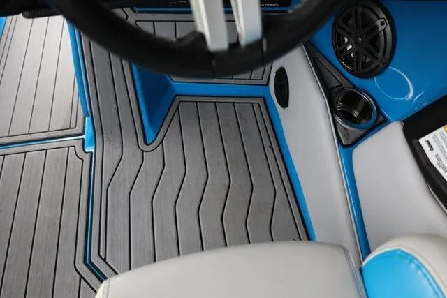 Slide: The Image of 2022 Nautique Super Air Nautique S23 interior with stylish flooring and speaker detail. - 33