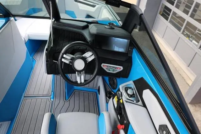 Slide: The Image of 2022 Nautique Super Air Nautique S23 interior with modern dashboard and steering wheel. - 35