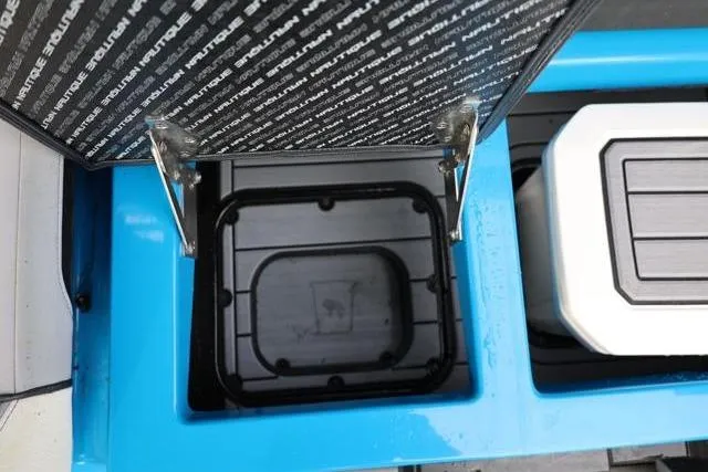 Slide: The Image of Storage compartment of 2022 Nautique Super Air Nautique S23 boat, open lid view. - 37