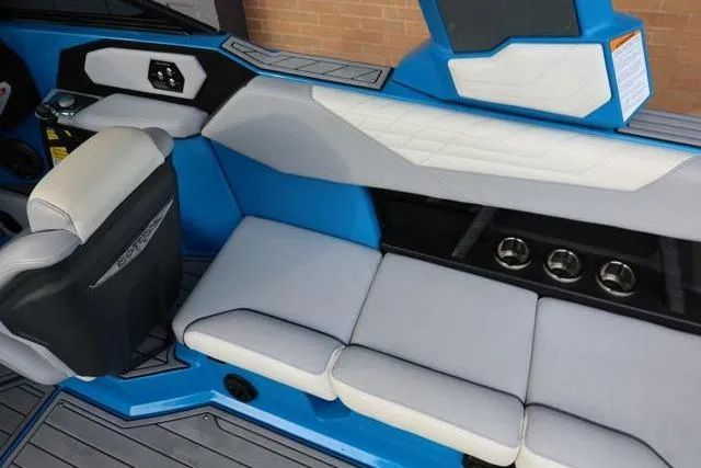 Slide: The Image of Interior of 2022 Nautique Super Air Nautique S23 boat with blue and white seating. - 39