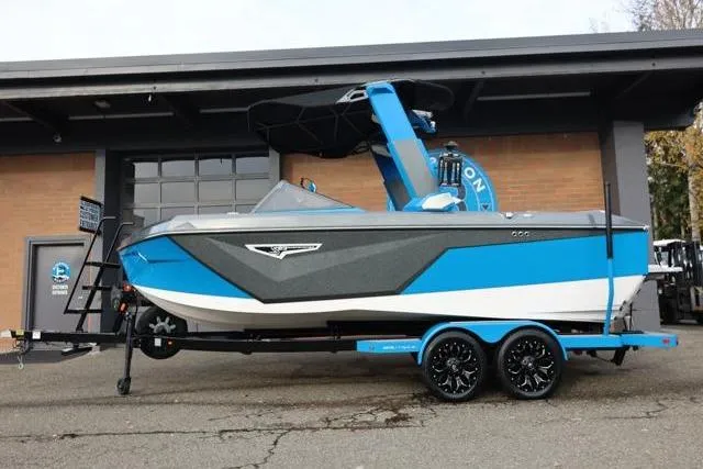 Slide: The Image of 2022 Nautique Super Air Nautique S23 boat in blue and white, parked on a trailer. - 4