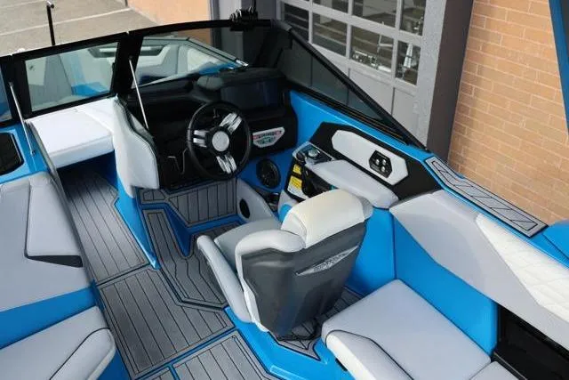 Slide: The Image of Interior of 2022 Nautique Super Air Nautique S23 boat, featuring modern design and blue accents. - 42