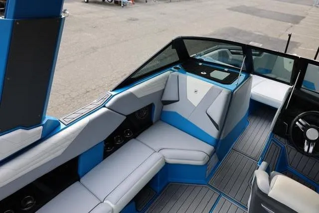 Slide: The Image of 2022 Nautique Super Air Nautique S23 interior with blue and white seating. - 44