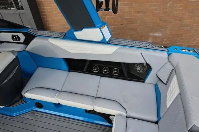 Slide: The Image of 2022 Nautique Super Air Nautique S23 interior with blue and gray seating. - 45